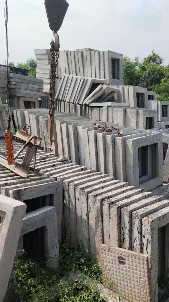 Crane lifting precast RCC chamber units at the Gurukrupa Enterprises yard
